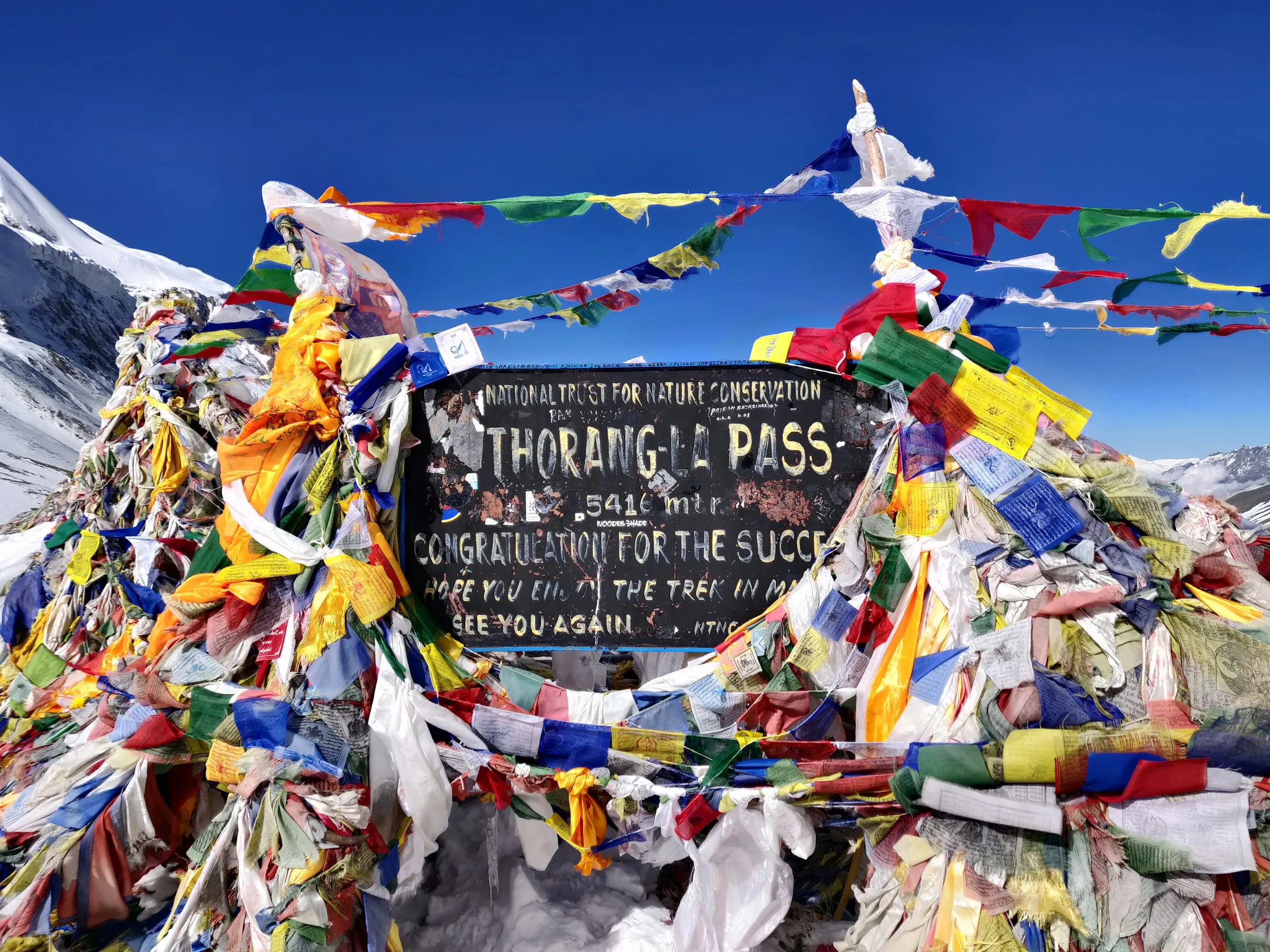 The Thorong La pass sign at 5,416 m on the Annapurna Circuit